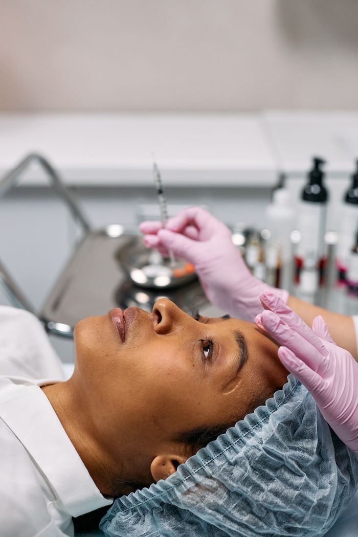 services-img Woman receiving cosmetic injection in clinical setting, showcasing beauty treatment process.